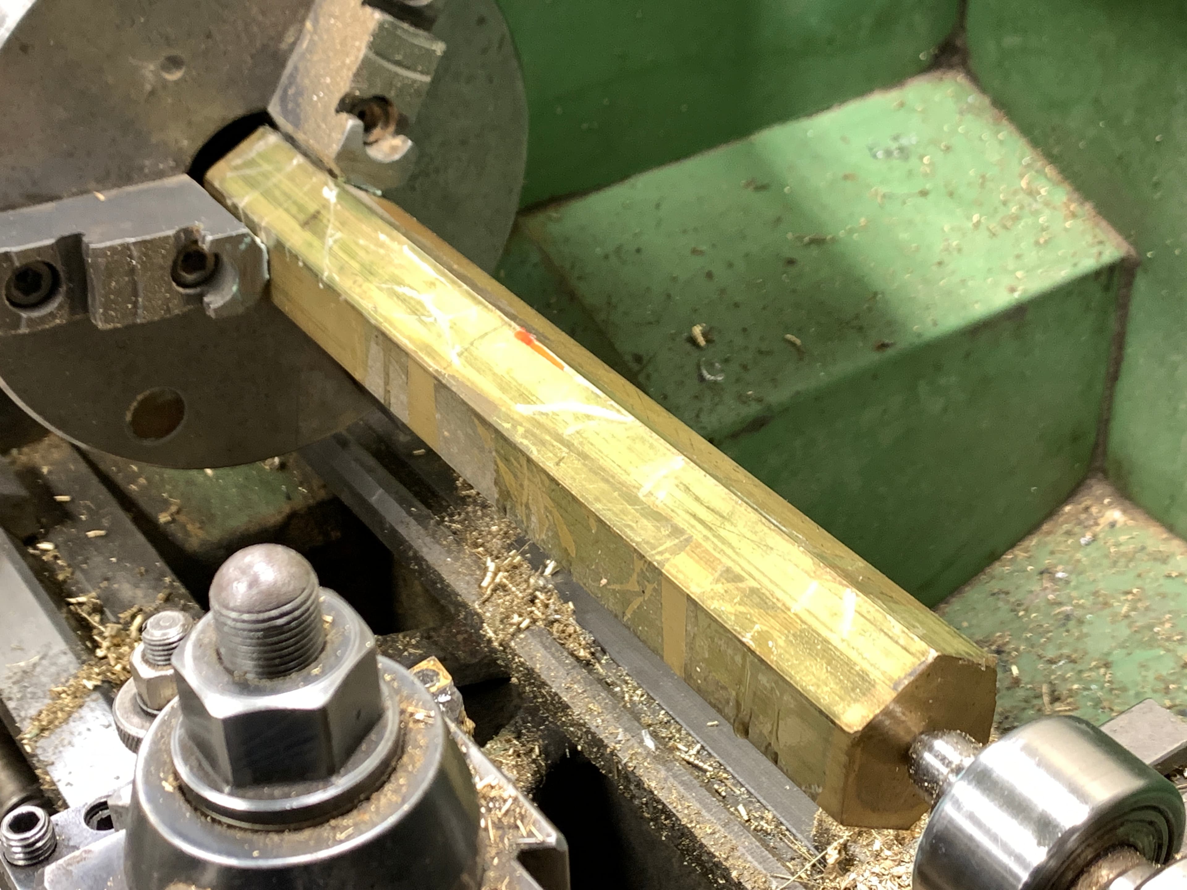 Brass stock mounted in the lathe.